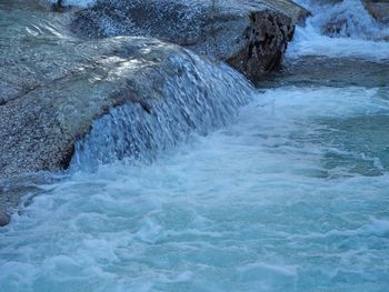 Water flowing through rocks in sea