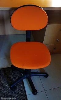 High angle view of orange chair against wall at home