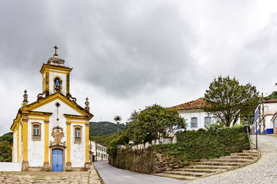 Temple by building against sky