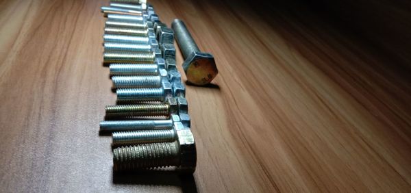 High angle view of machine part on wooden table