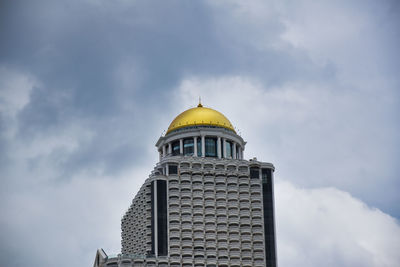 Low angle view of building against cloudy sky