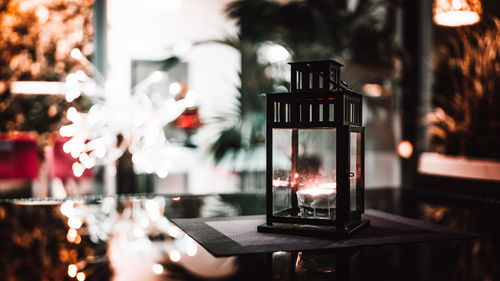 Close-up of illuminated lantern on table