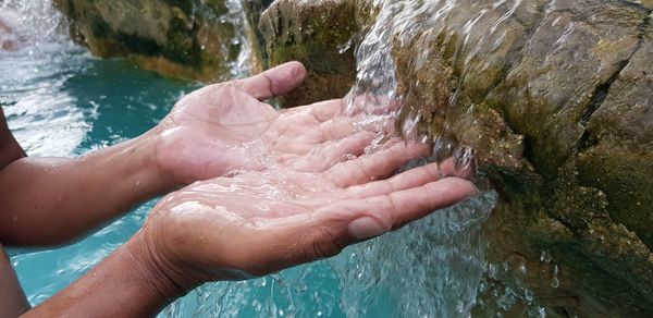 High angle view of hands over water