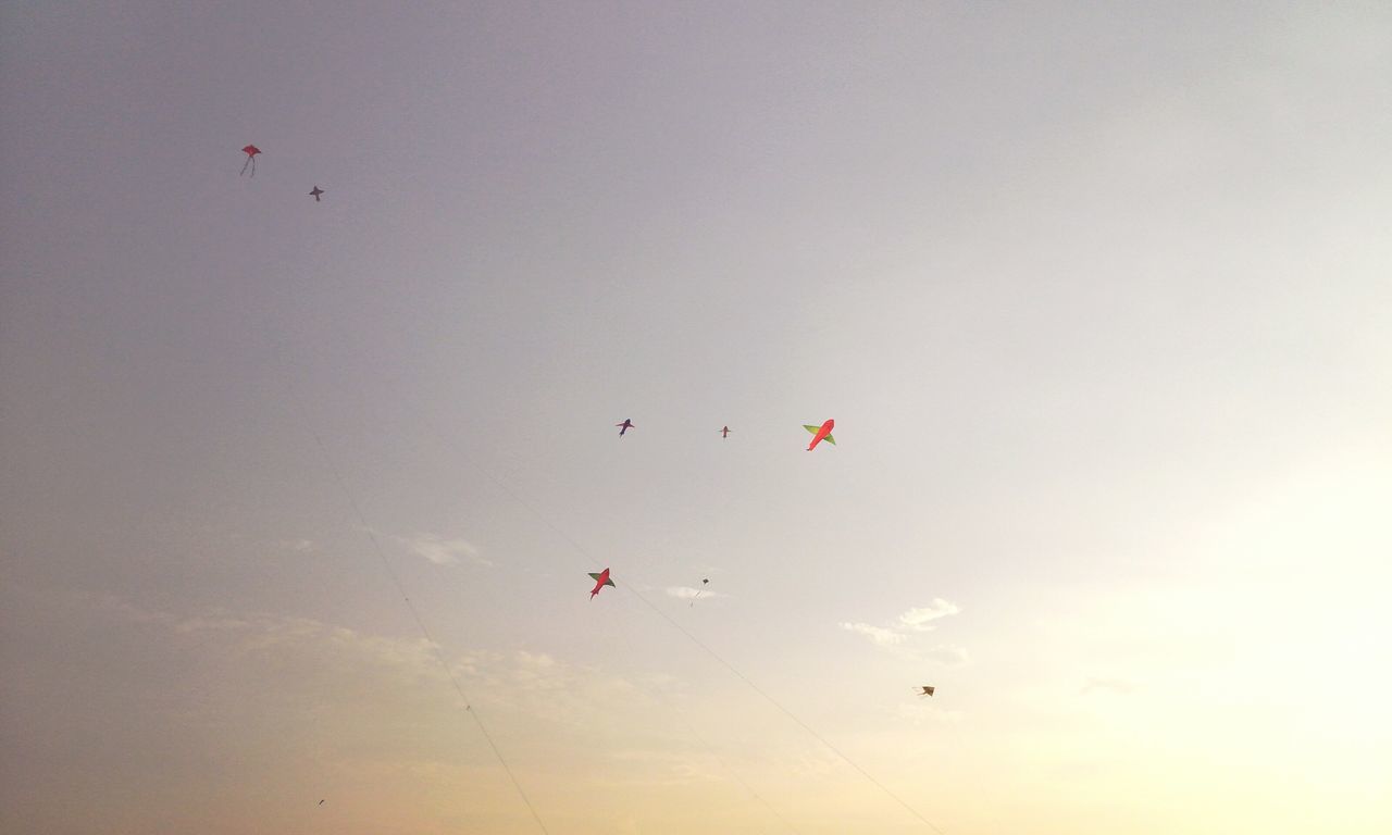 flying, mid-air, low angle view, sky, parachute, transportation, air vehicle, kite - toy, freedom, paragliding, motion, adventure, copy space, leisure activity, exhilaration, kite, nature, extreme sports, fun, parachuting