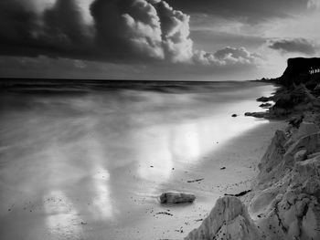 Scenic view of sea against cloudy sky