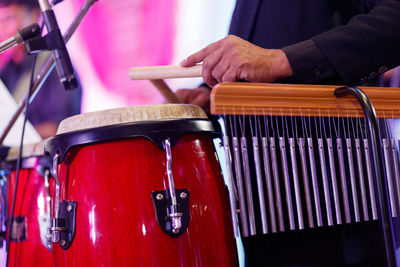 Midsection of musician playing instruments at music festival