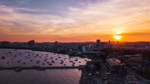 High angle view of buildings against cloudy sky during sunset