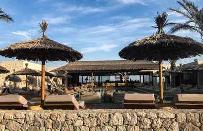 Built structure on beach against sky