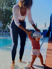 Full length of woman in swimming pool against sea