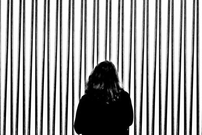 Portrait of woman standing against wall