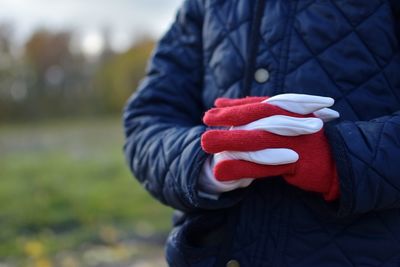 Close-up of human hand in snow