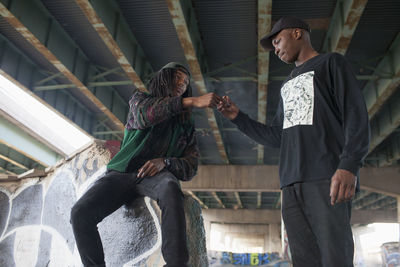 Two young men at a skateboard park.