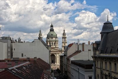 View of cityscape against cloudy sky