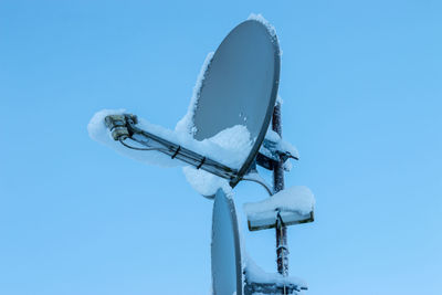 Low angle view of communications tower against clear sky