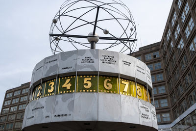 Low angle view of clock tower against sky in city