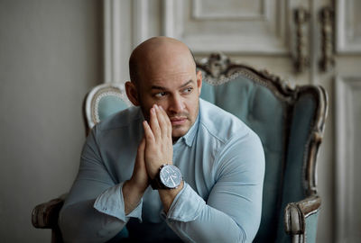 Portrait of man sitting on chair