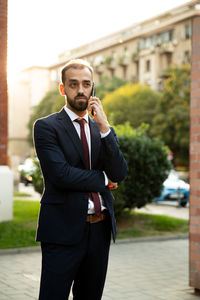 Portrait of businessman standing in city