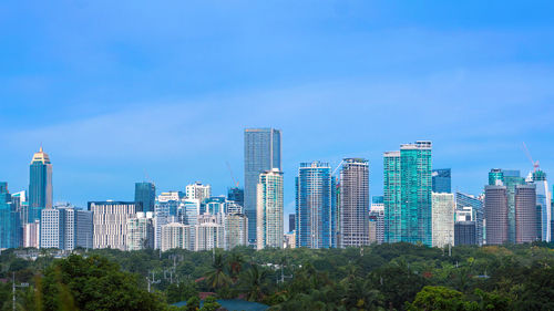 View of skyscrapers against blue sky