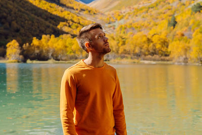 Rear view of man standing in lake