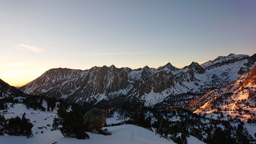 Scenic view of snowcapped mountains against sky during sunset