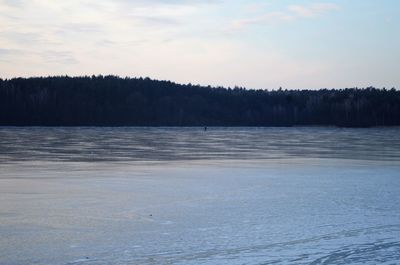 Scenic view of lake against sky during winter