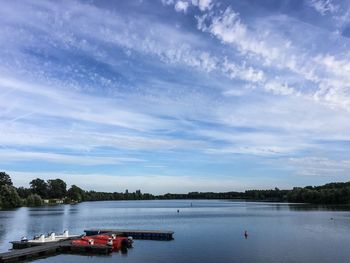 Pier amidst boats moored in river