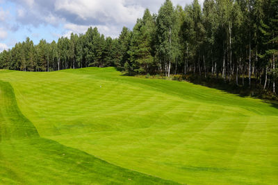 Scenic view of golf course against sky