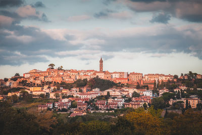 Old town by buildings in city against sky