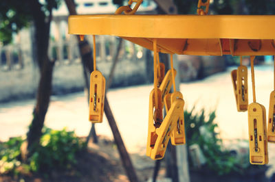 Close-up of clothespins hanging on clothesline