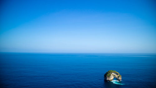 Scenic view of blue sea against clear sky
