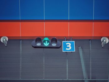 Low angle view of illuminated lighting equipment on wall