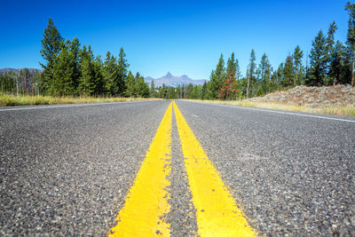 Surface level of road against blue sky