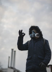 Portrait of man with mask photographing against sky during ok after corona outbrake in berlin 2020