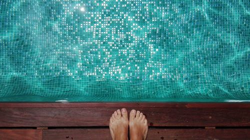 Low section of woman at swimming pool