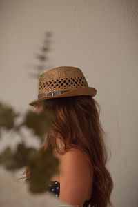 Portrait of young woman wearing hat