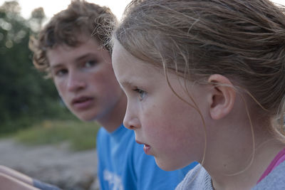 Close-up of siblings outdoors