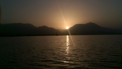 Scenic view of lake at sunset