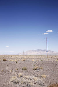 Scenic view of desert against blue sky