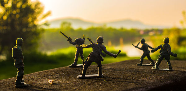 Close-up of toy soldiers on retaining wall