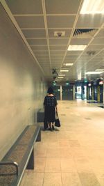 Rear view of man walking in subway