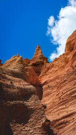 Scenic view of rocky mountains against blue sky