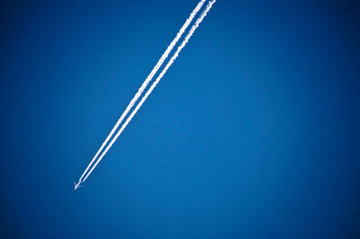 Airplane flying against clear blue sky