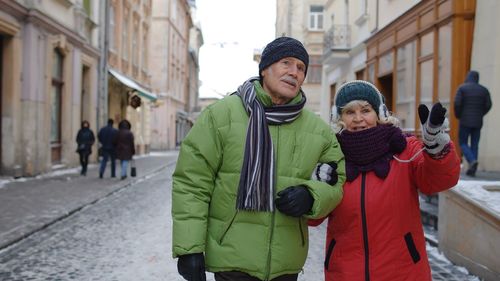 Senior couple walking outdoors during winter