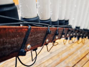 Close-up of piano hanging on wood