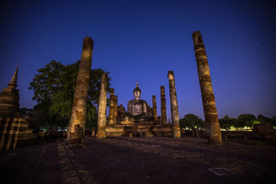 Panoramic view of old temple building against blue sky at night