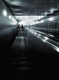 People on escalator at subway station