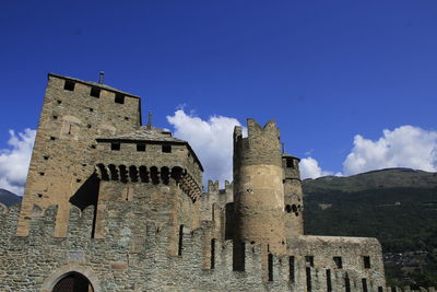 Low angle view of historic building against blue sky