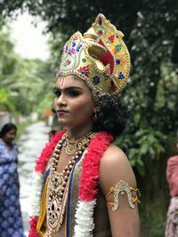 Portrait of smiling friends in traditional clothing standing outdoors