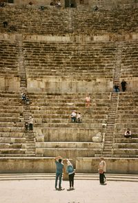 People walking on brick wall