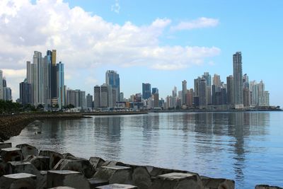 View of cityscape against cloudy sky